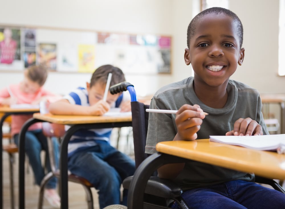 Disabled pupil smiling at camera in classroom at the elementary school-1